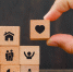 Relationship concept on wooden background side view. hand holding wooden cube with heart icon. - Городская Газета