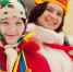 Two happy girls celebrating  Shrovetide  at Russia - Городская Газета